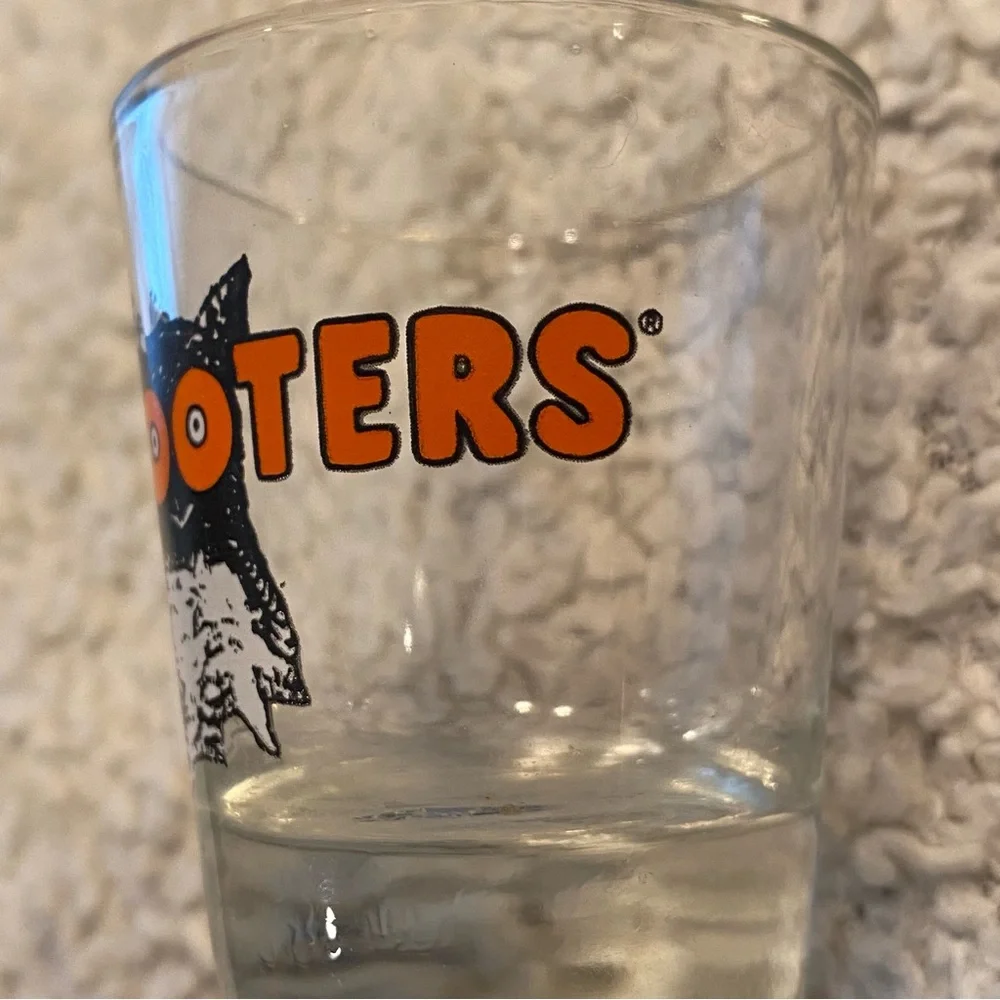 Hooter’s shot glass,  white orange with owl logo, no city specified